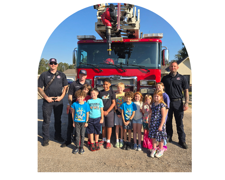 BMFL students with local firefighters and fire truck during educational visit