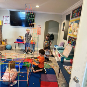 Students building with colorful geometric blocks in classroom